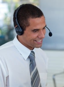 Businessman with a headset on in a call center