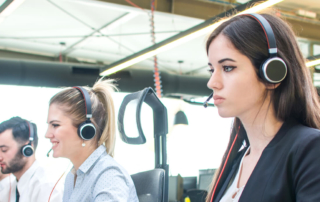 a customer experience outsourcing agent wearing a headset at work