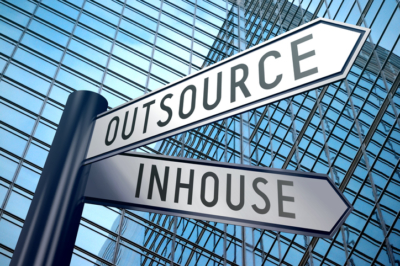 Crossroads sign with two arrows, office building - inhouse, outsource