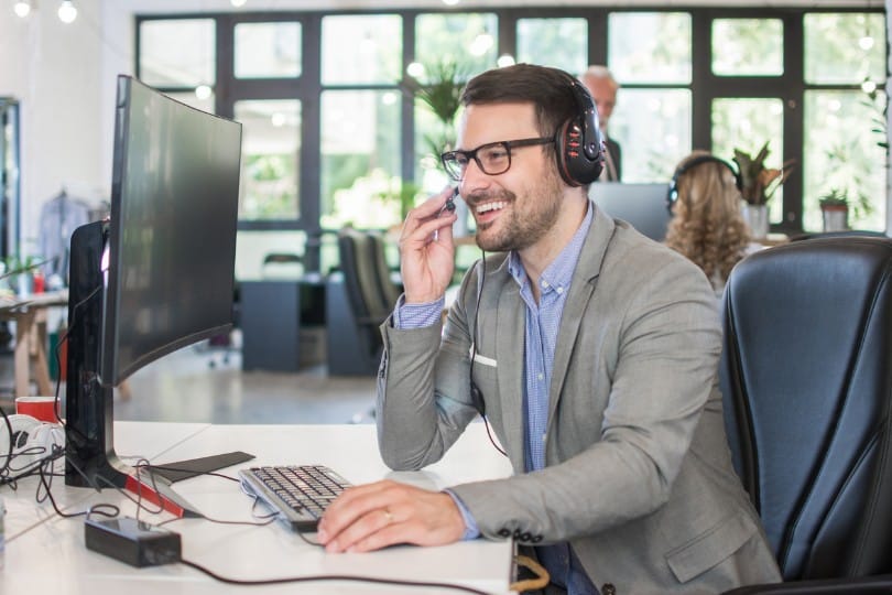 Call center agent following up with a client.