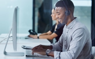 two call center agents typing