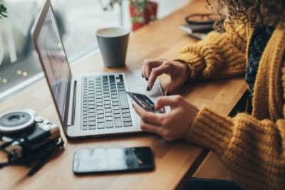 someone making a purchase on their computers as a result of a businesses strategy to lower their customer acquisition costs.