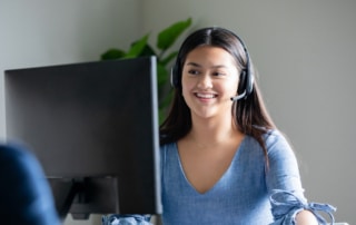 a person wearing a headset working in a call center in the Philippines.