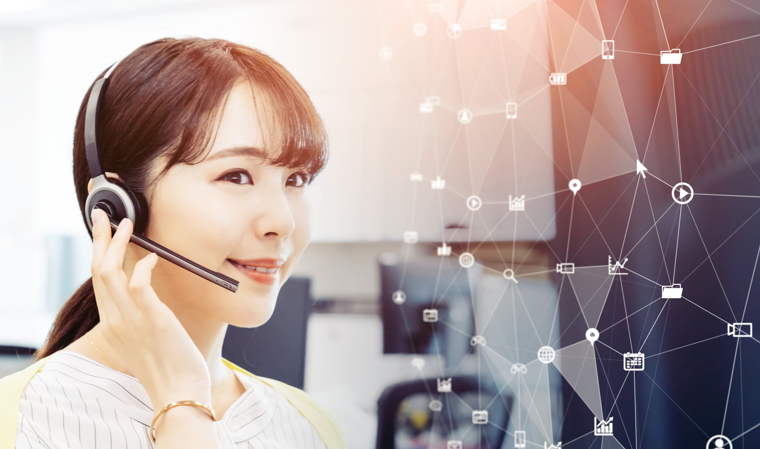 A cheerful call center agent providing great customer service using cloud contact center software, visualized by a web of icons in front of her.