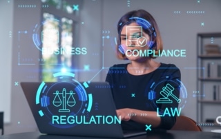 Woman sits at a laptop while TCPA-related words, like business, compliance, regulation, and law, are overlaid on the image