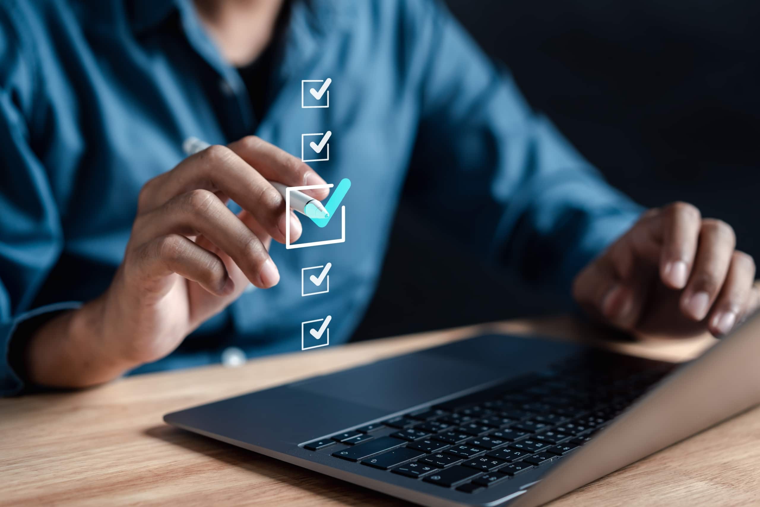 Person sits at a laptop, checking off a digital checklist pasted over the image