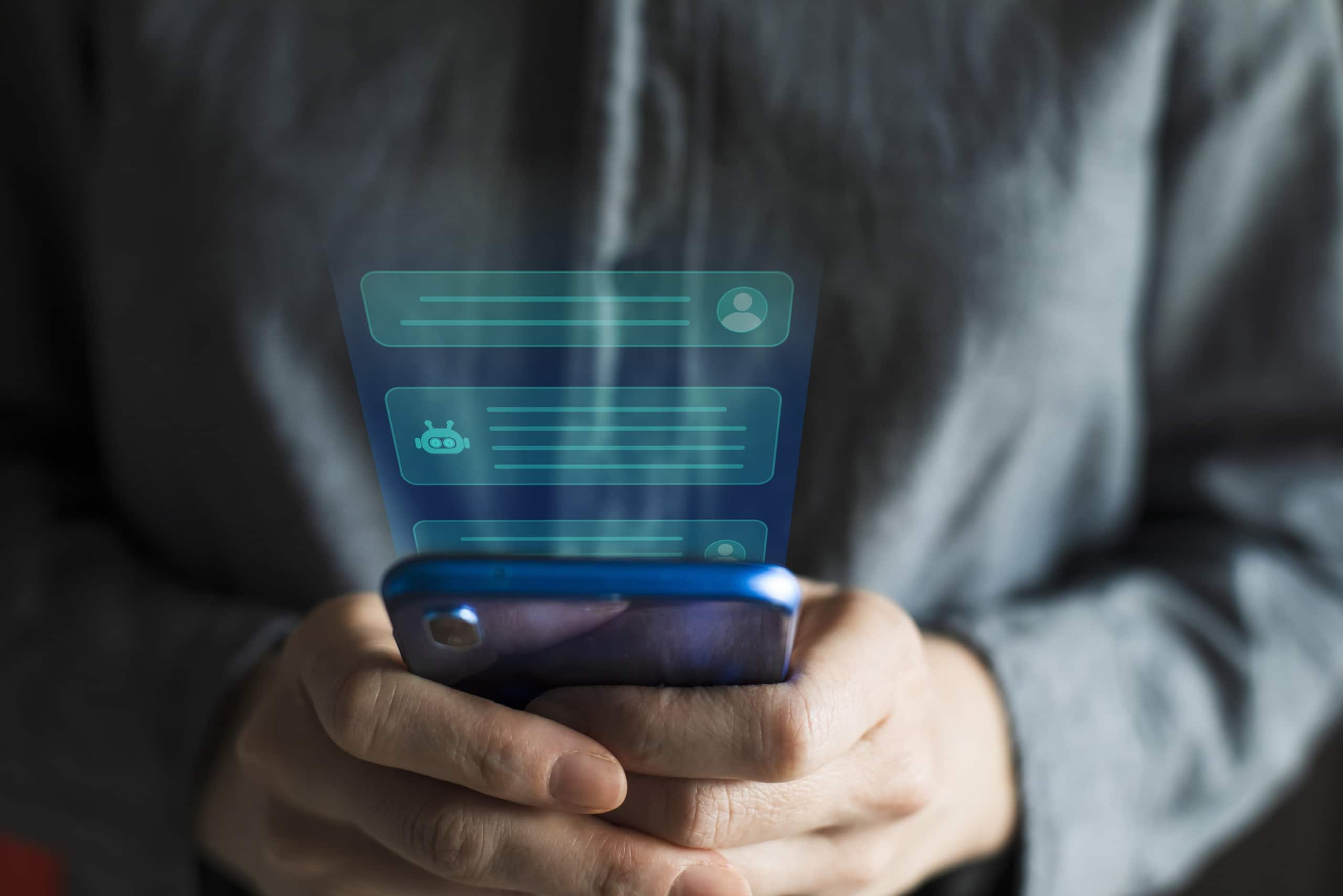 Hands holding a smartphone, with messages between the user and an AI chatbot rising up out of the phone.