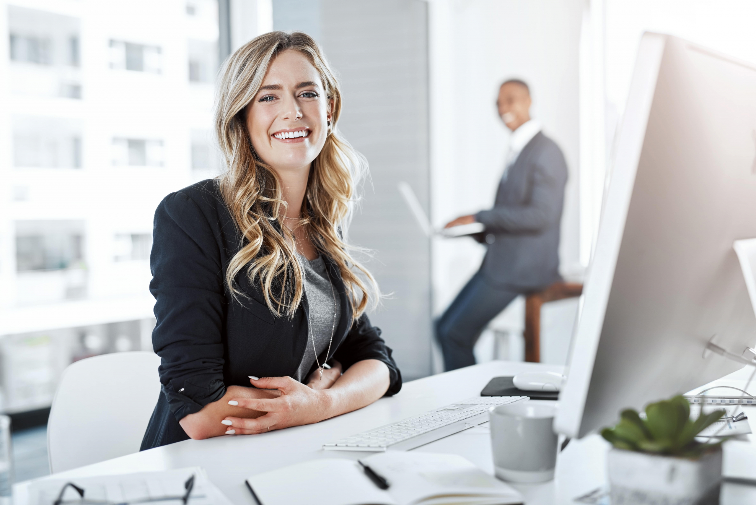 Business woman by computer for a job in the office.
