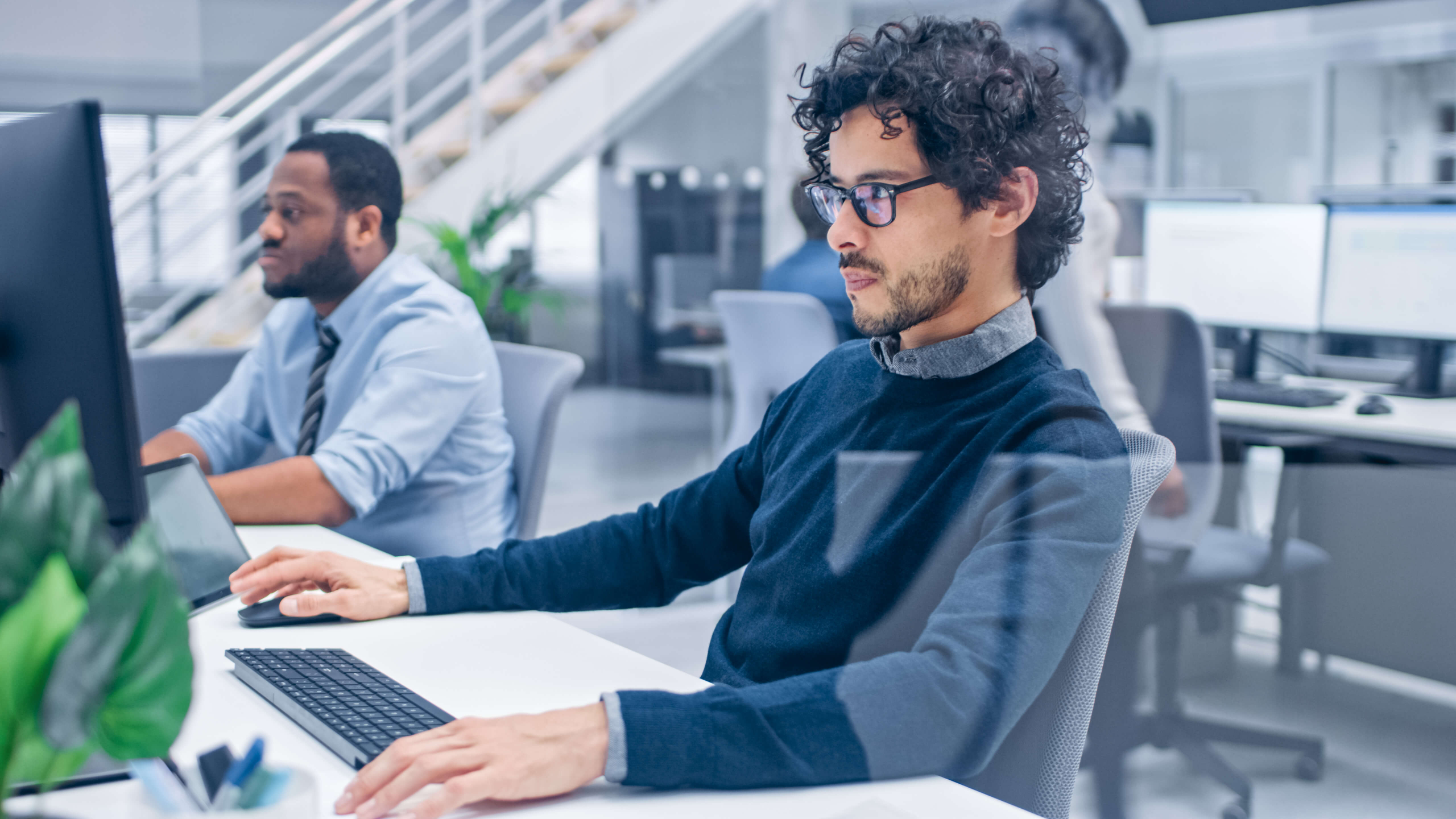 group of multi-ethnic help desk coworkers on their computers