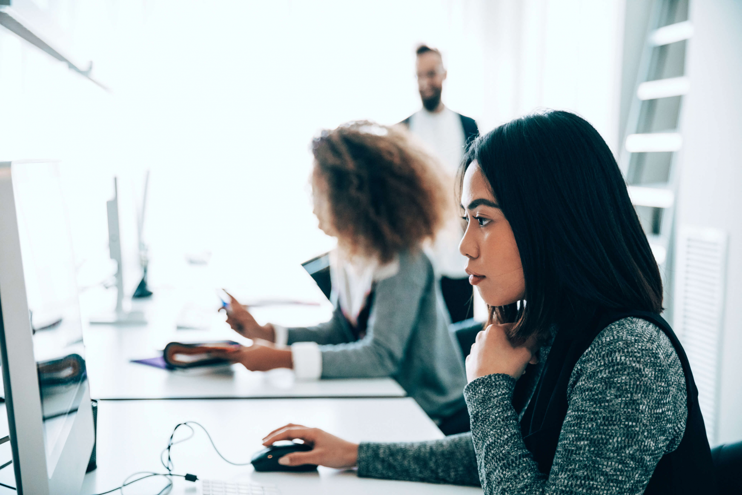 multi-ethnic omnichannel customer support workers on computers