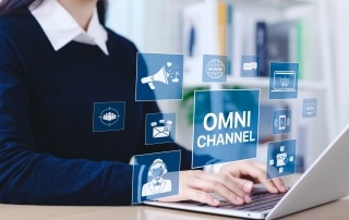 A customer support agent on the computer using multiple channels to communicate with customers.