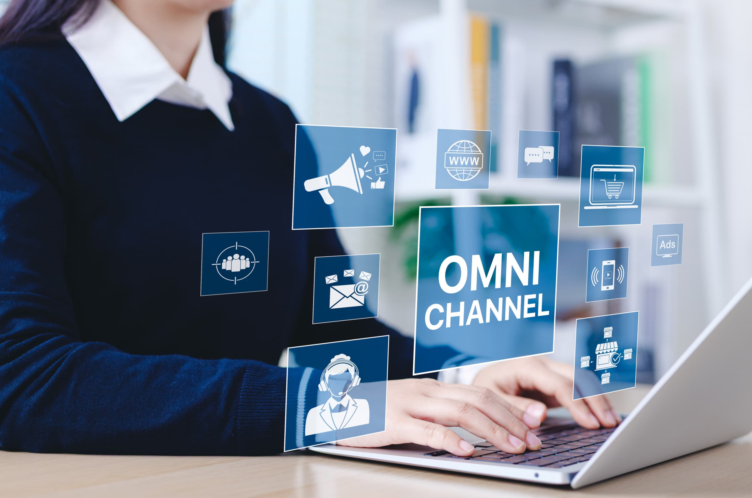 A customer support agent on the computer using multiple channels to communicate with customers.