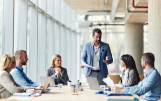 Employees working together at a table for workforce management.