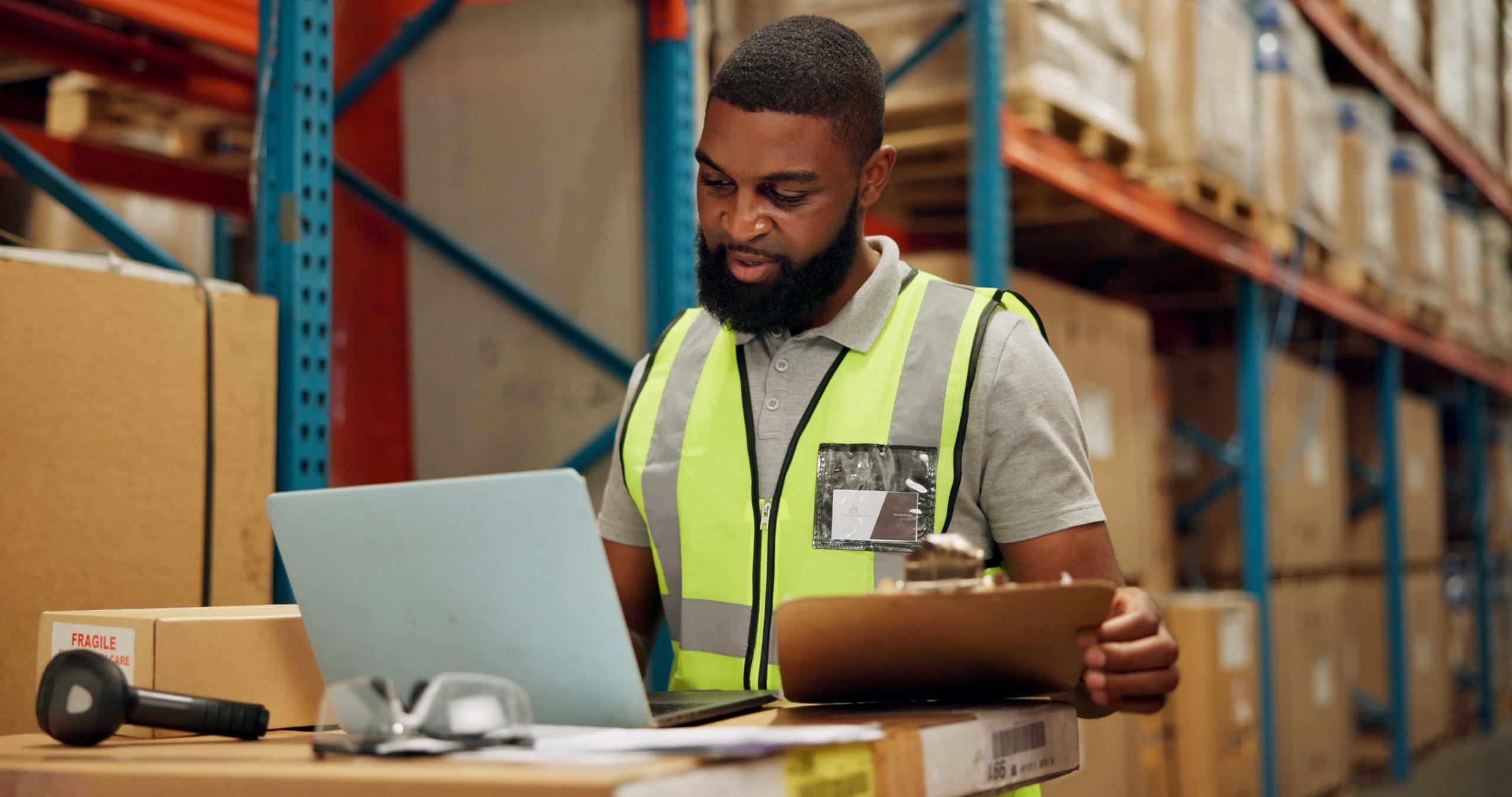 African American man checking inventory in a warehouse