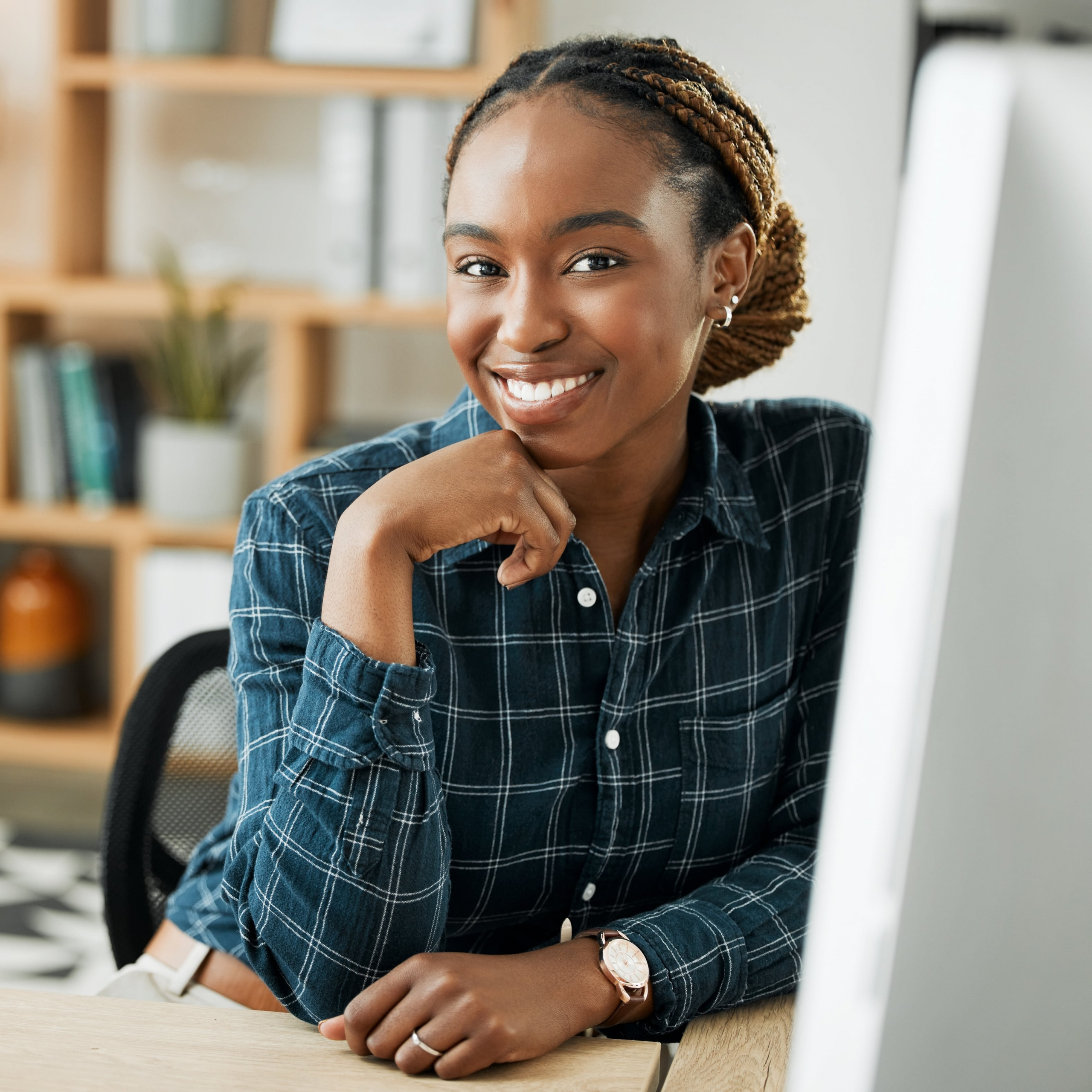 African american woman sitting at a computer smiling