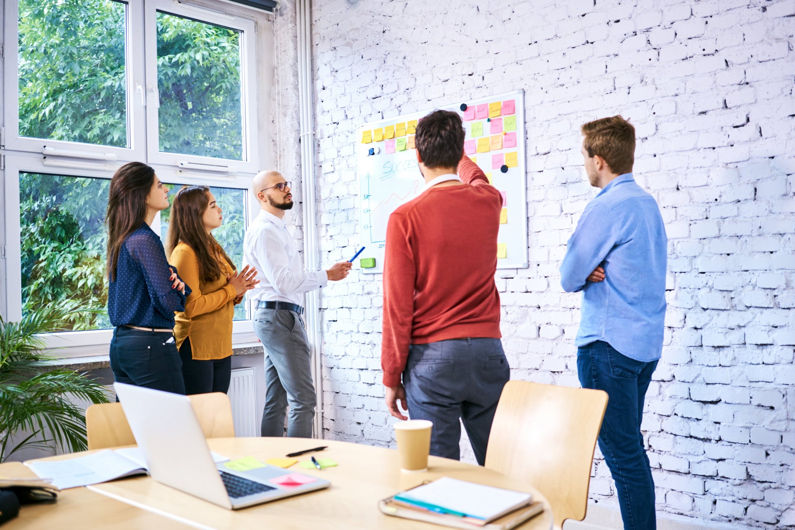 small business leaders brainstorming on a whiteboard