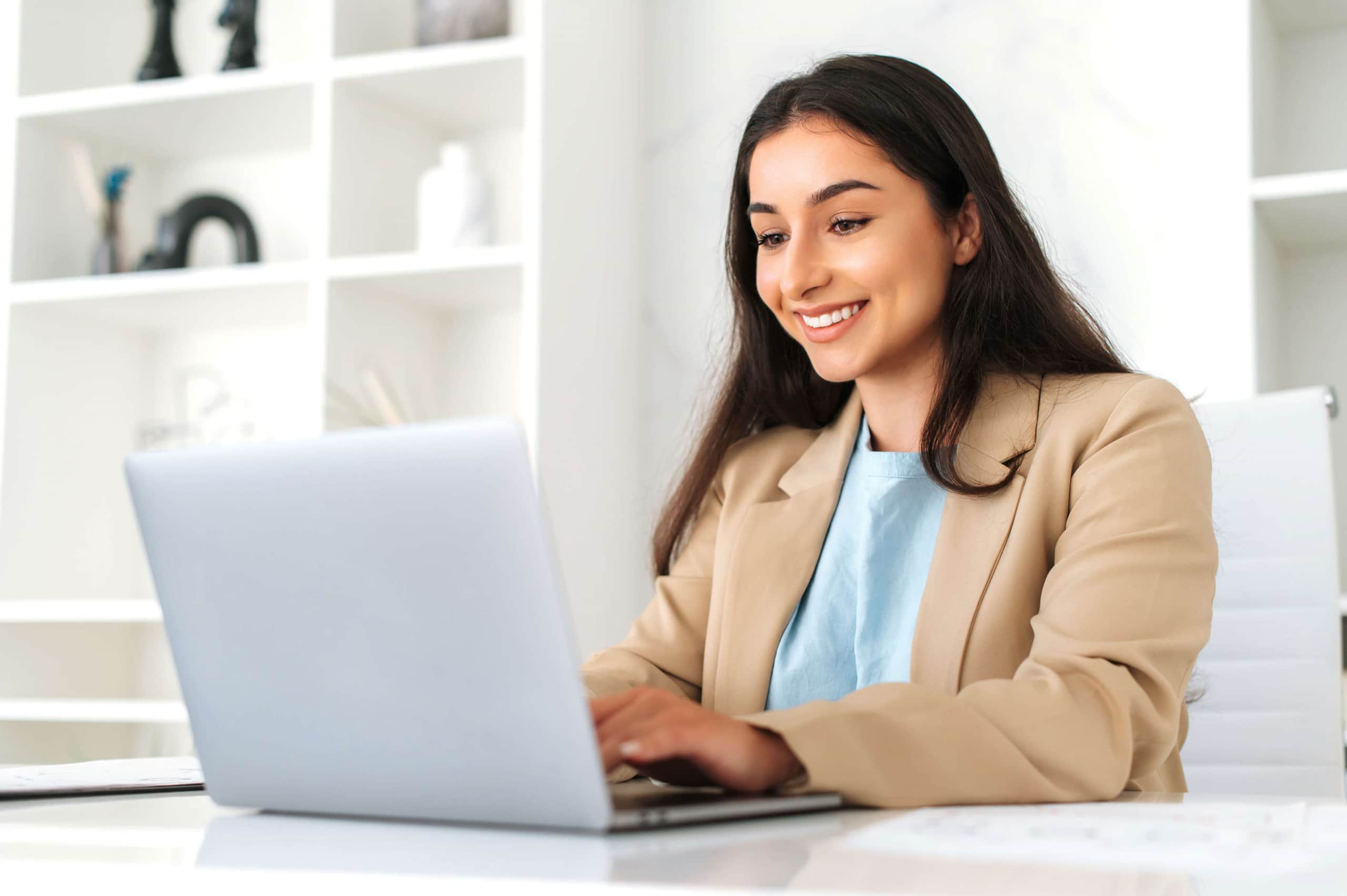 Young Latin woman working on her computer in her office