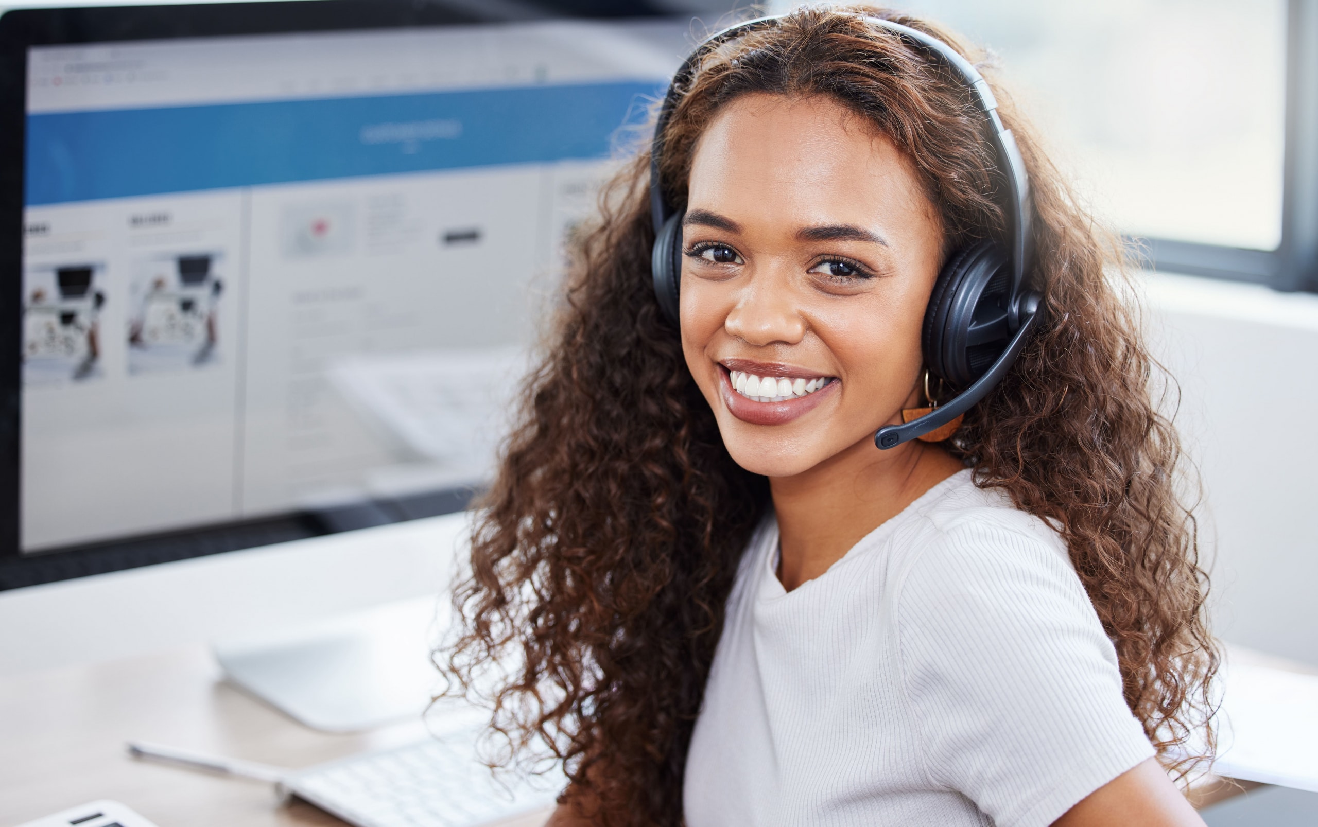 Happy, portrait and woman in call center with computer screen, headset and lead generation. Telemarketing, virtual assistant or confident customer service consultant on website for online booking.