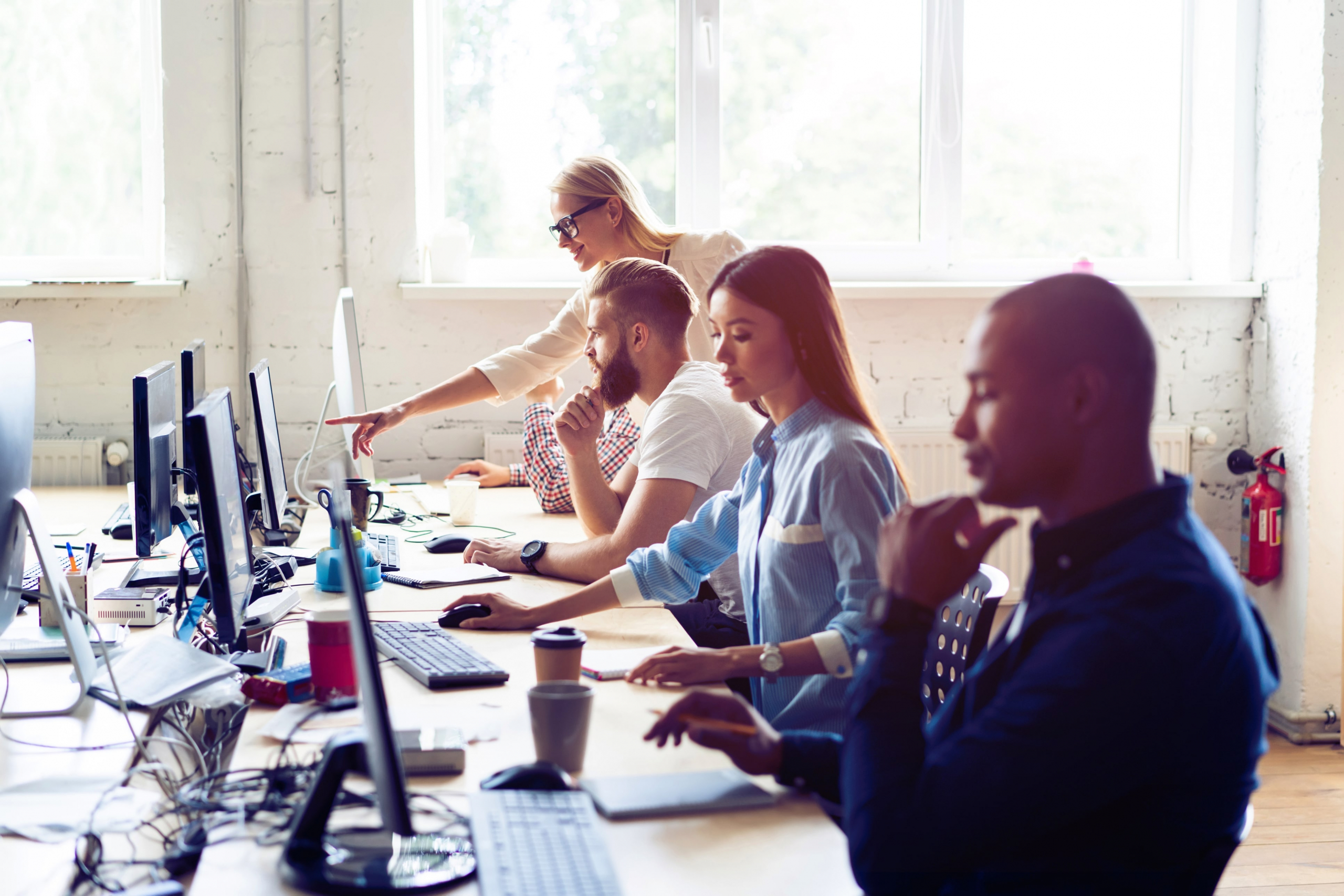 Group of customer retention and acquisition employees working at their computers