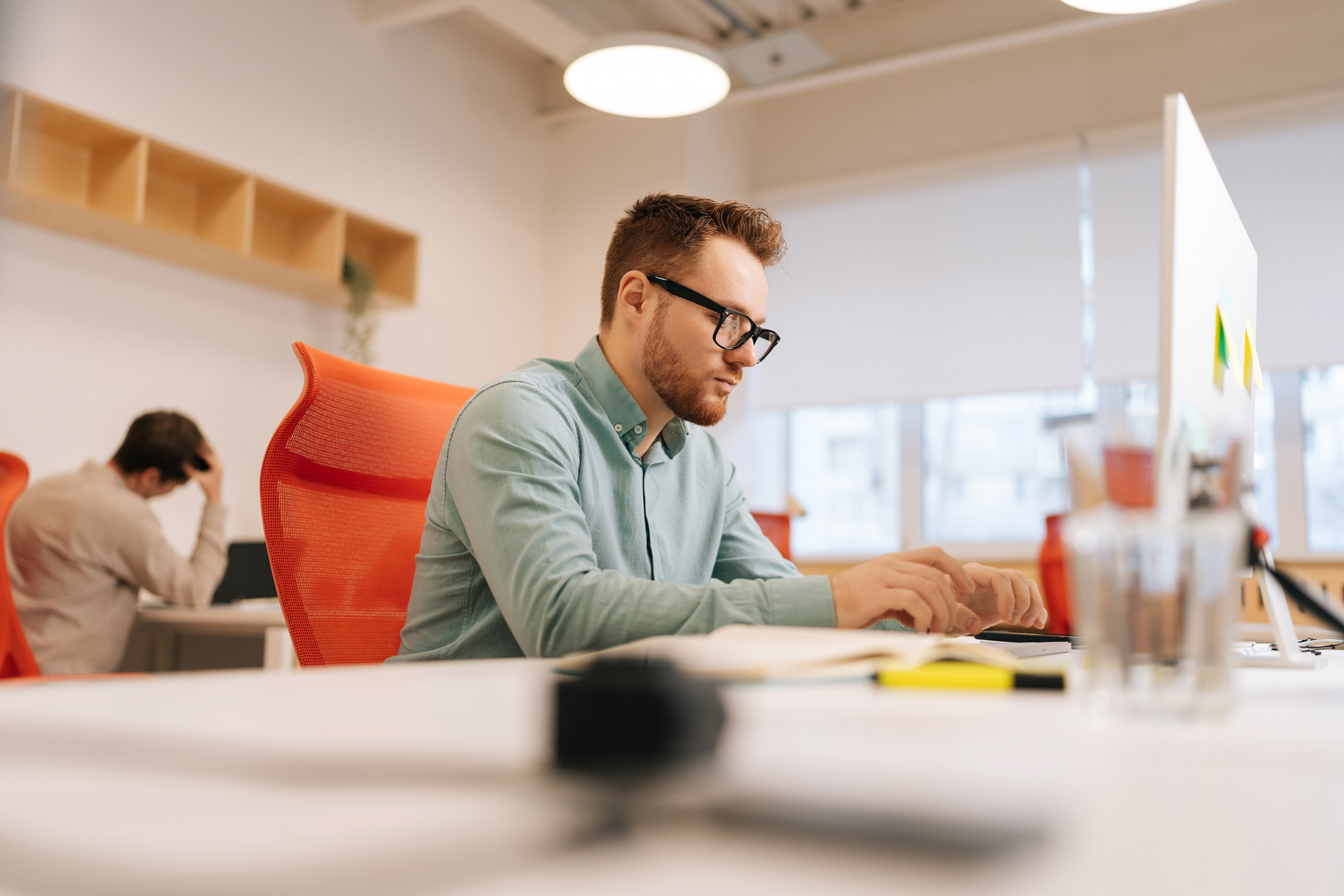 male worker sitting at his desk working on his computer