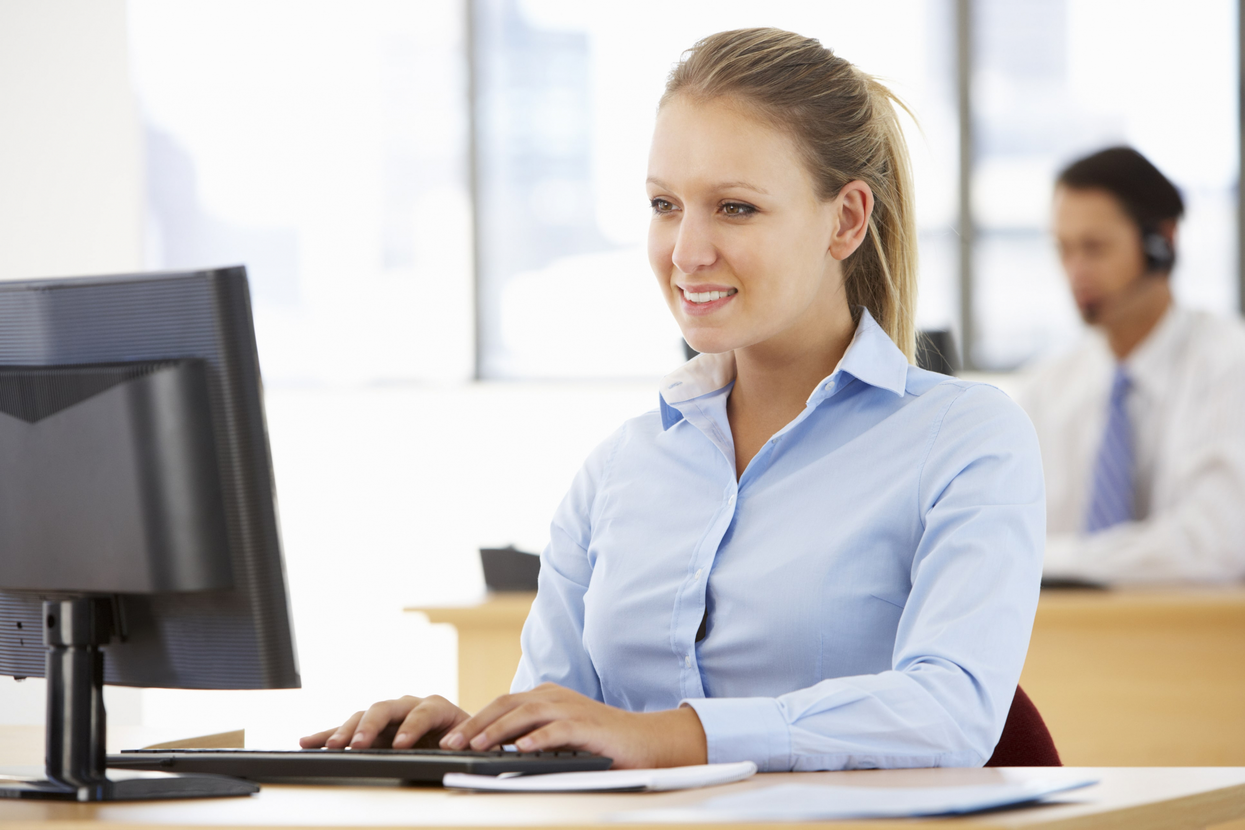 Female working on her computer live chatting with a customer
