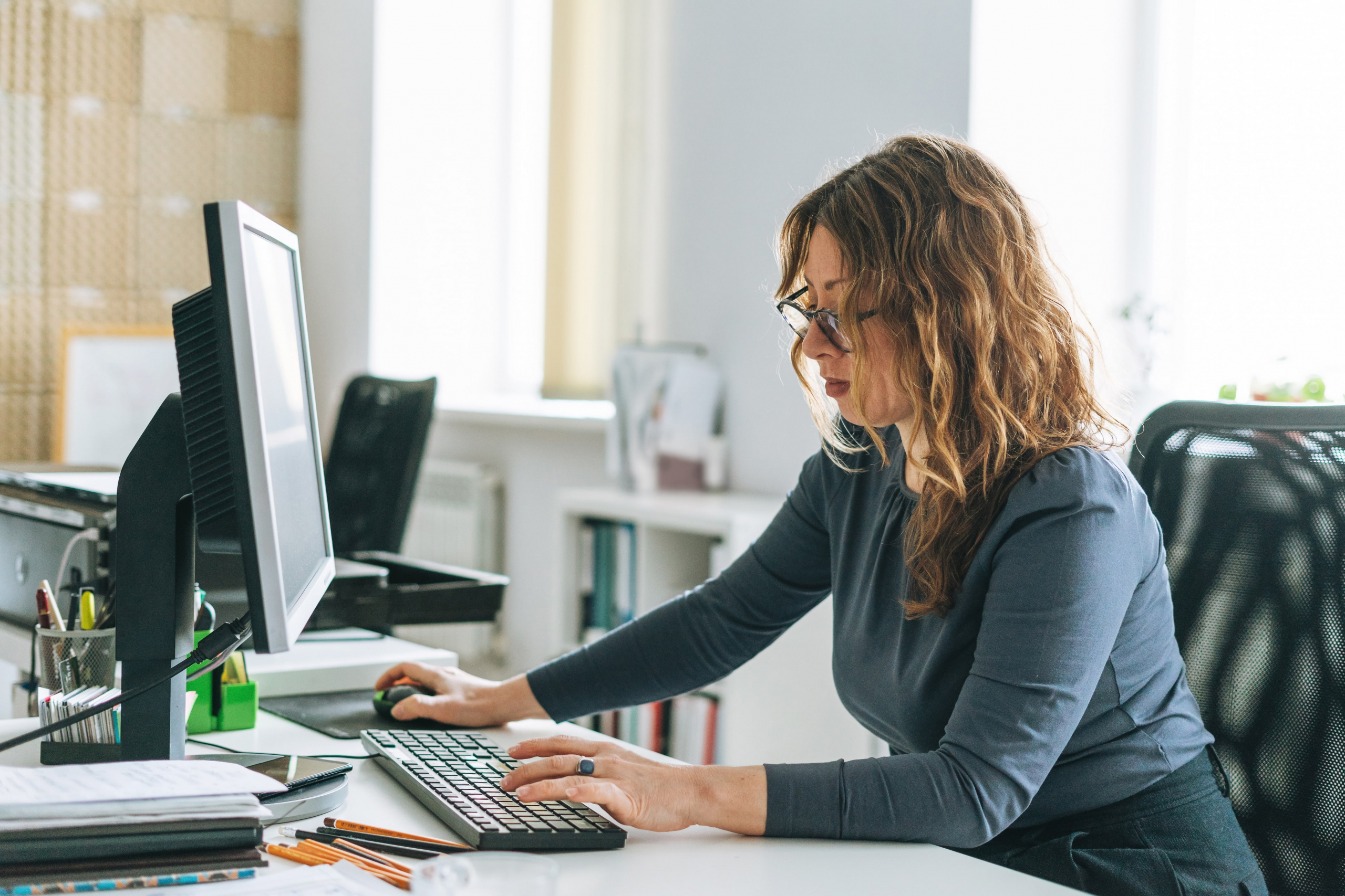 young amercan female working on her computer in a modern office