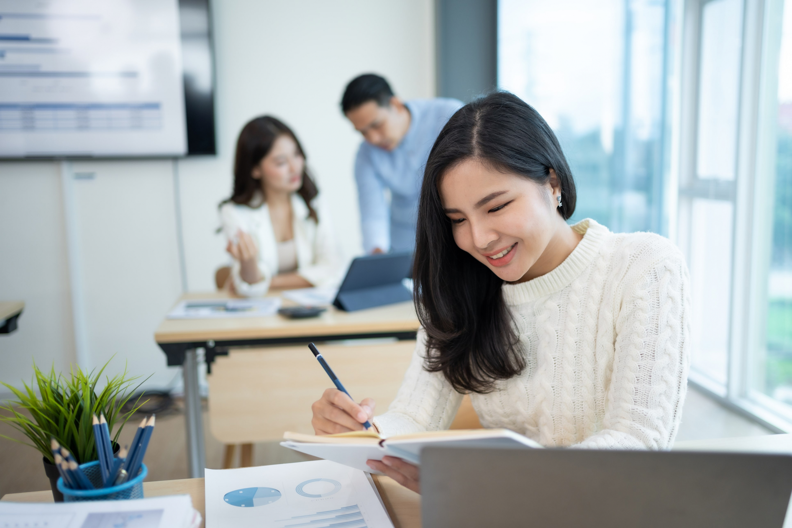 Young Asian woman working at her computer