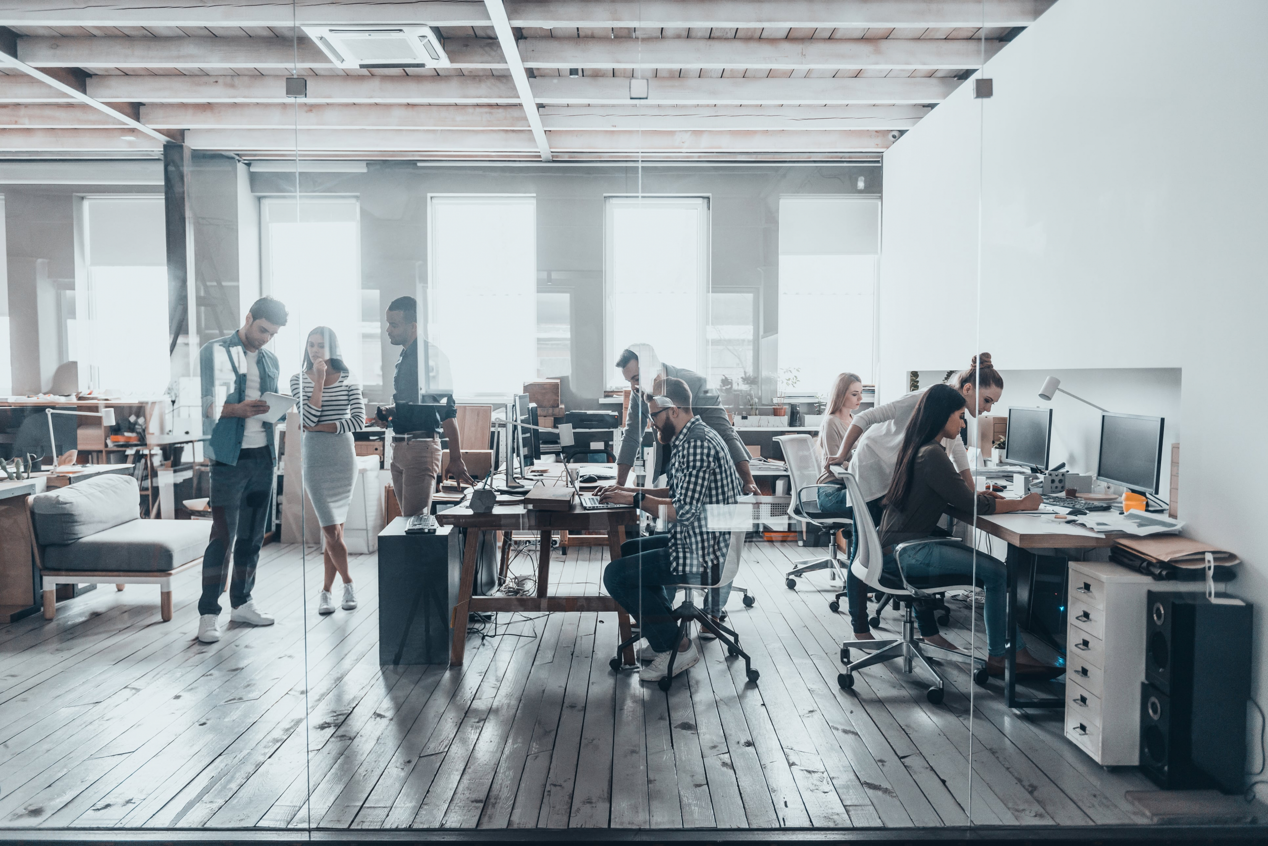 group of office workers in a modern office on their computers
