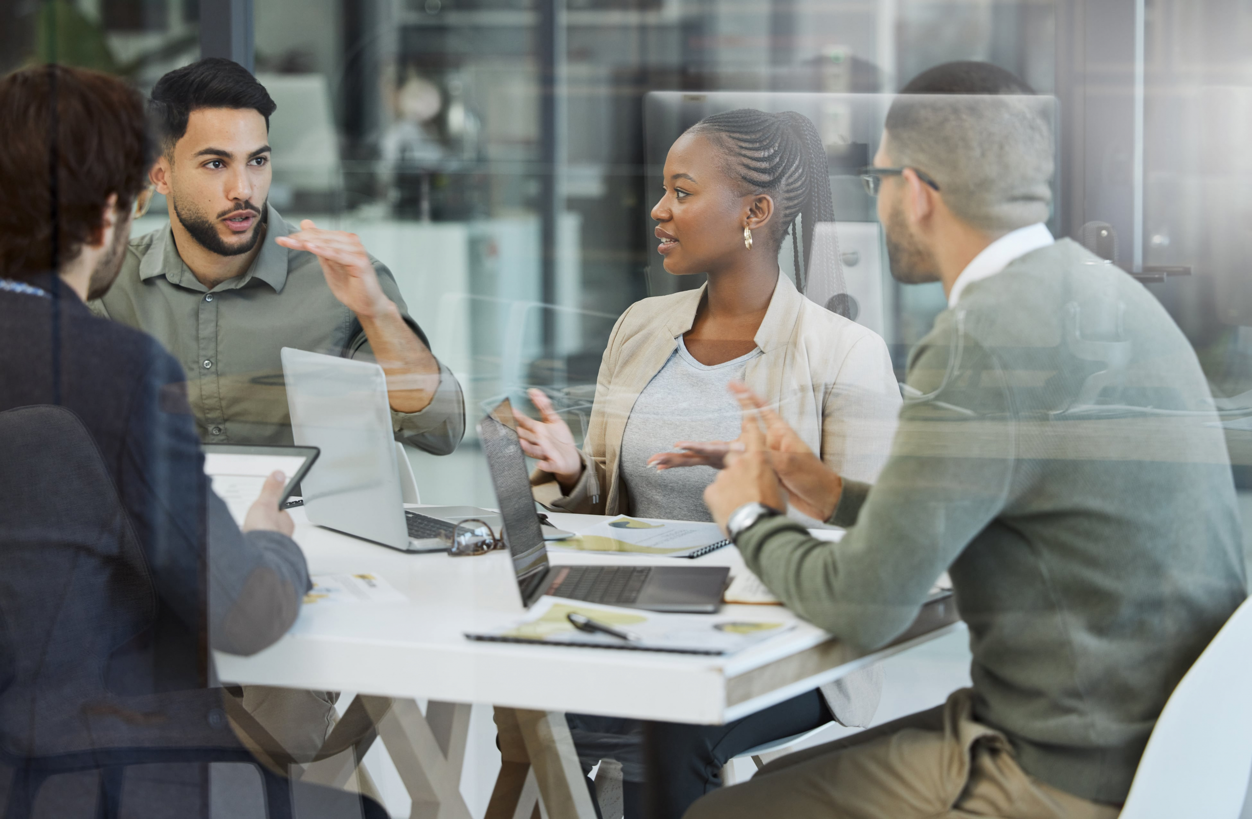 Co-workers in a meeting talking at a conference table