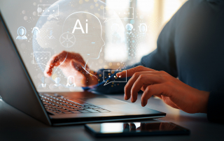 A person typing on a laptop with an icon overlaying an AI graphic bot.