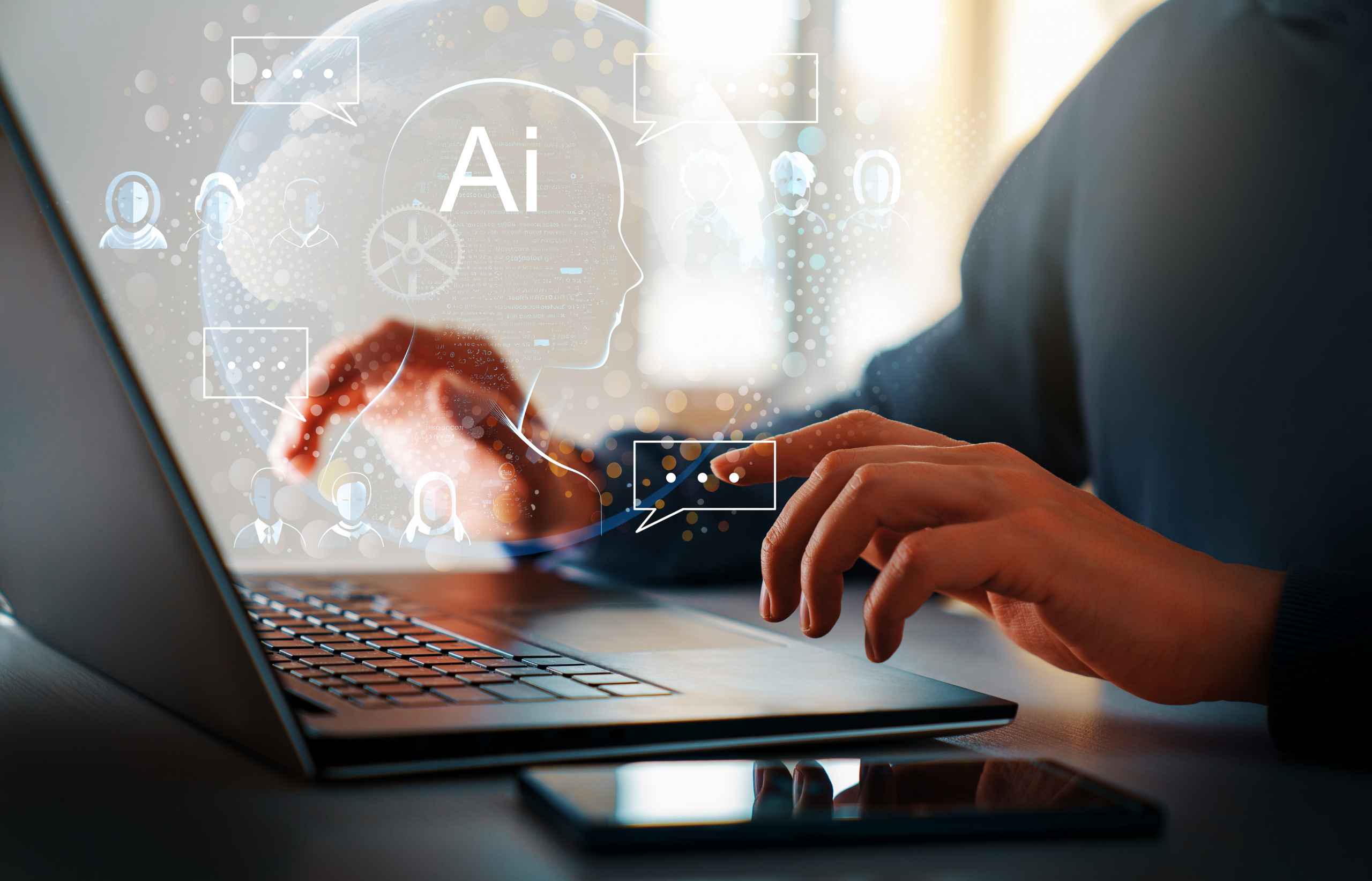 A person typing on a laptop with an icon overlaying an AI graphic bot.