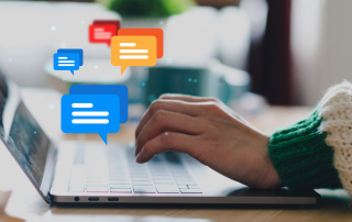 An image of a person typing on a laptop with overlay icons of chat bubbles.
