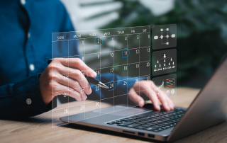 A person on their laptop scheduling an appointment with a virtual calendar image.