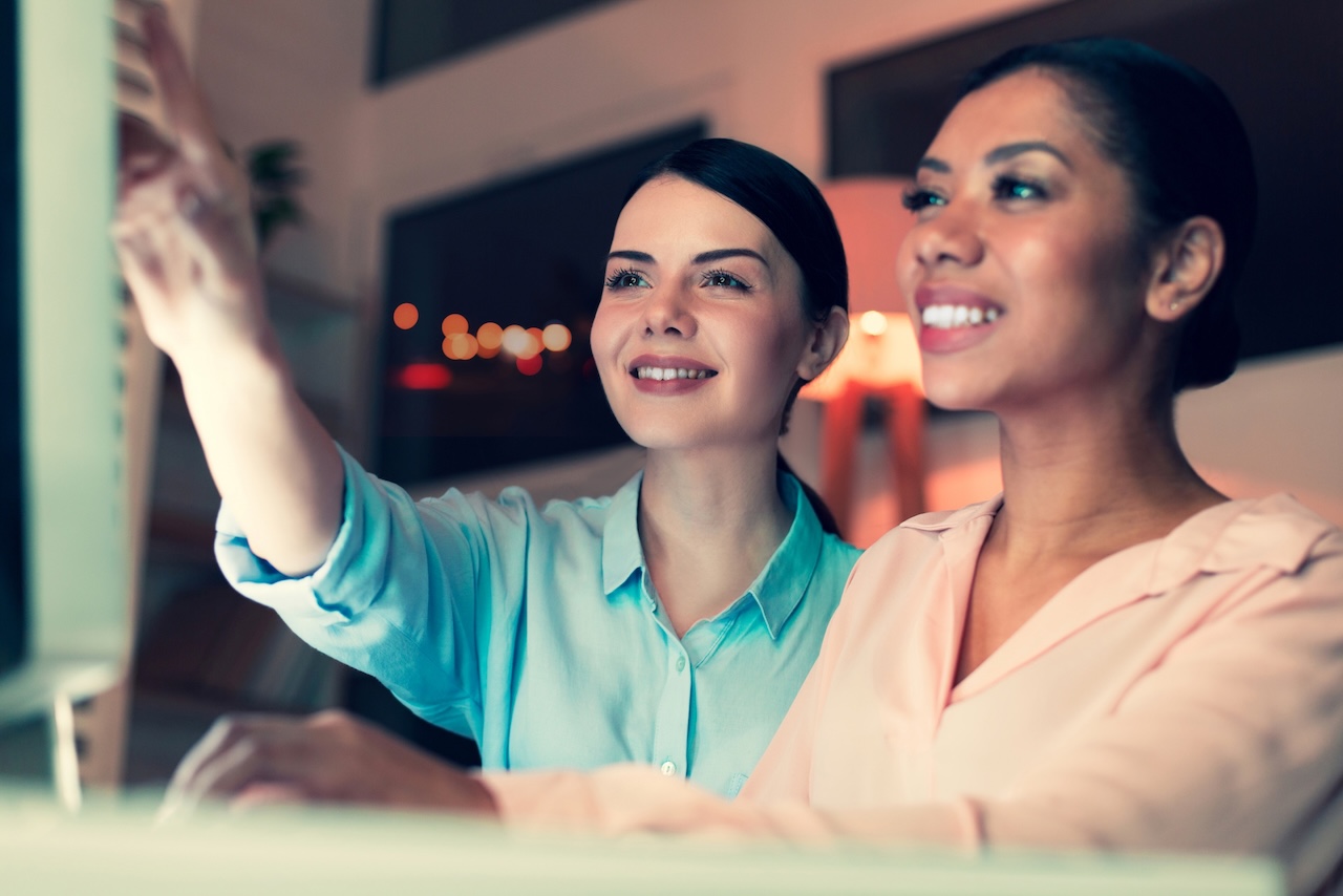 Best,Cooperation.,Upbeat,Young,Women,Sitting,At,One,Table,In