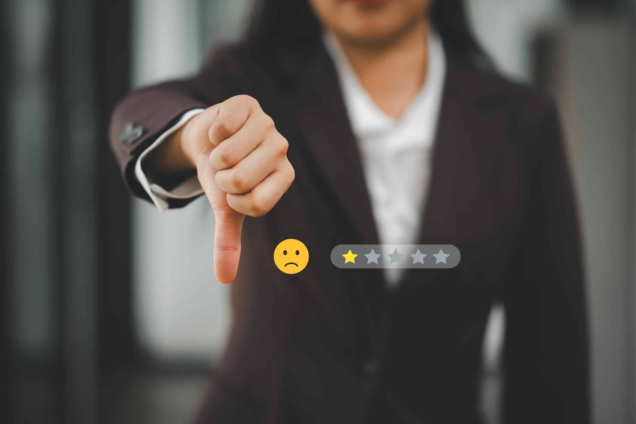 A CX agent with thumbs down and an overlay of a frowny face and 1 1-star review.