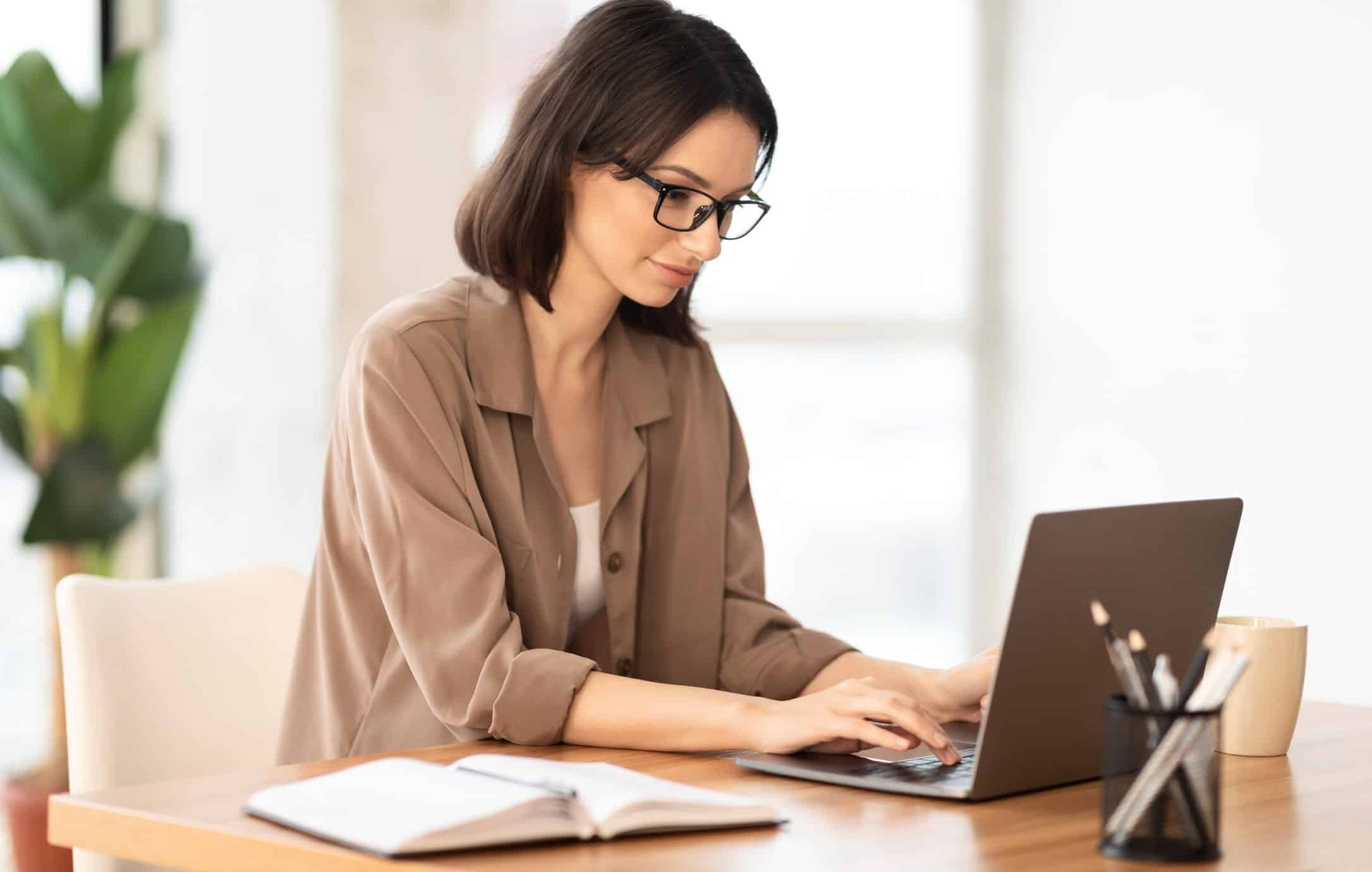 young woman on her laptop writing an email