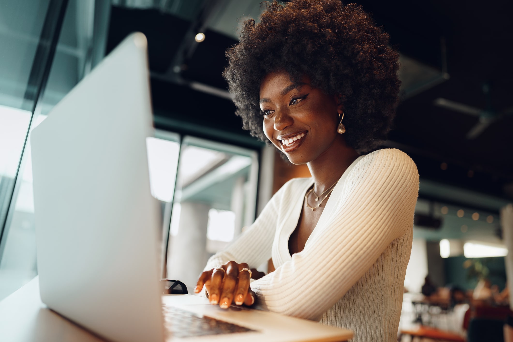 young african american woman smiling on her laptop