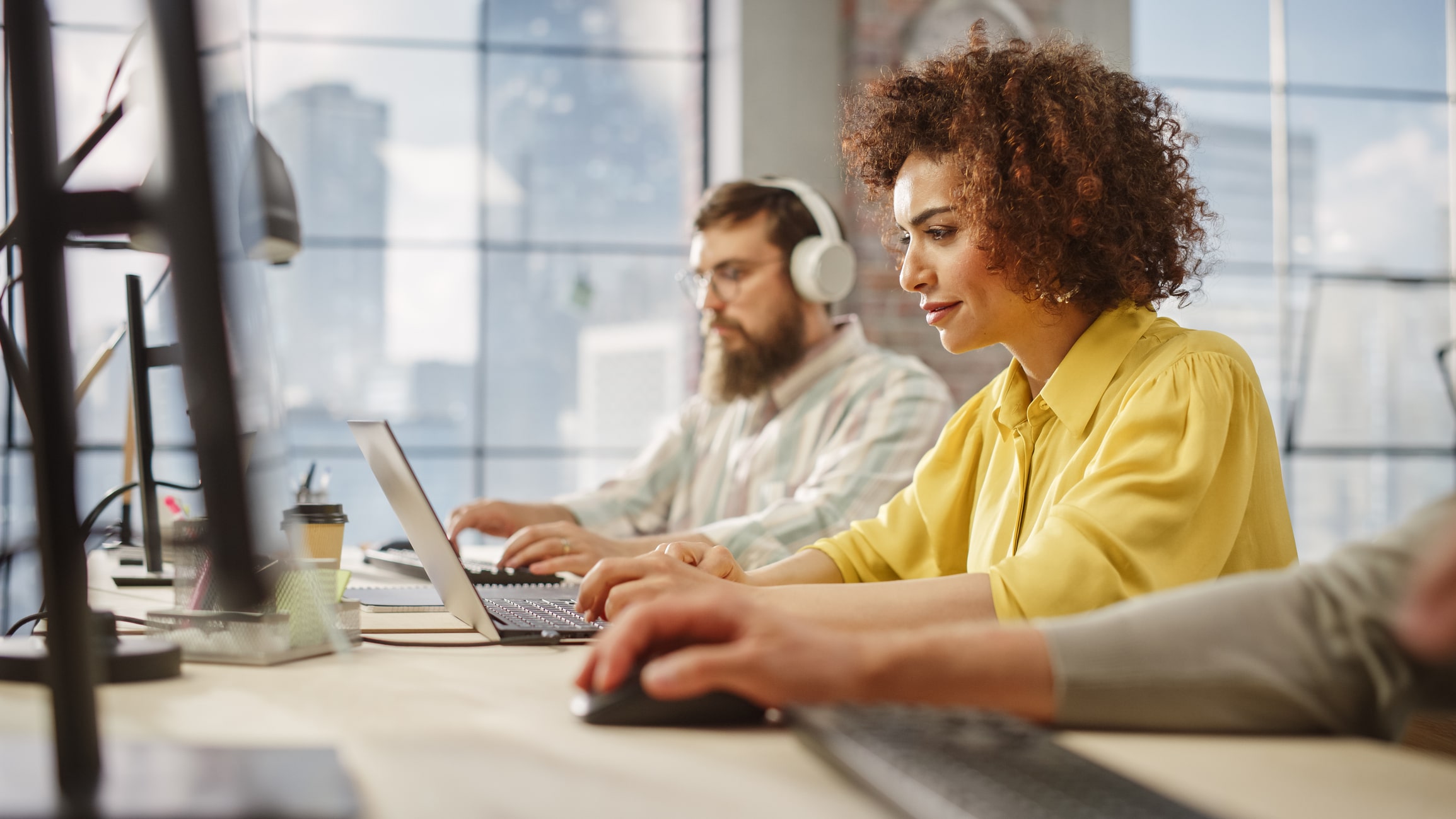 outsourced email support service agents working on their computers