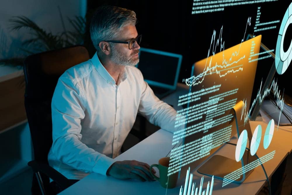 human in the loop older male with a beard working on a computer with ai technology